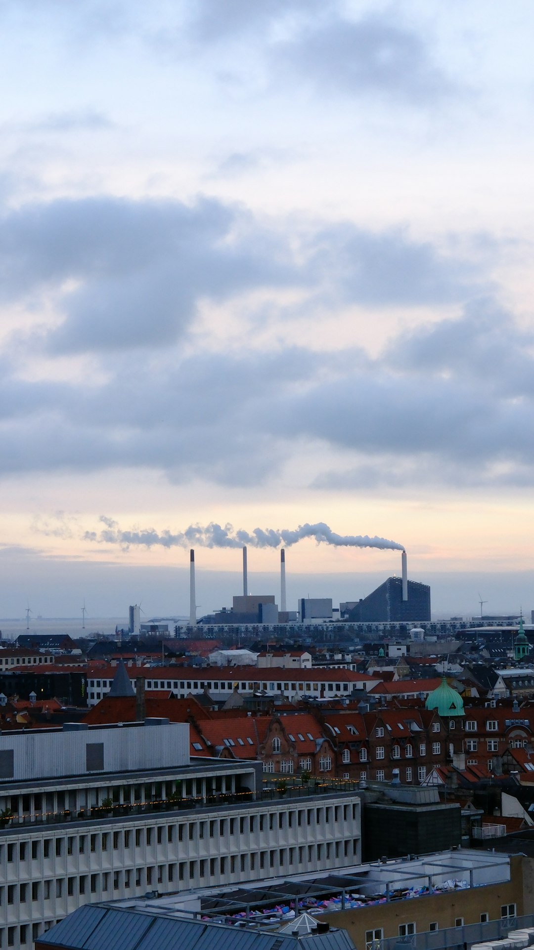 cityscape-with-smoking-industrial-chimneys-under-cloudy-sky-eeyaft3o7-o